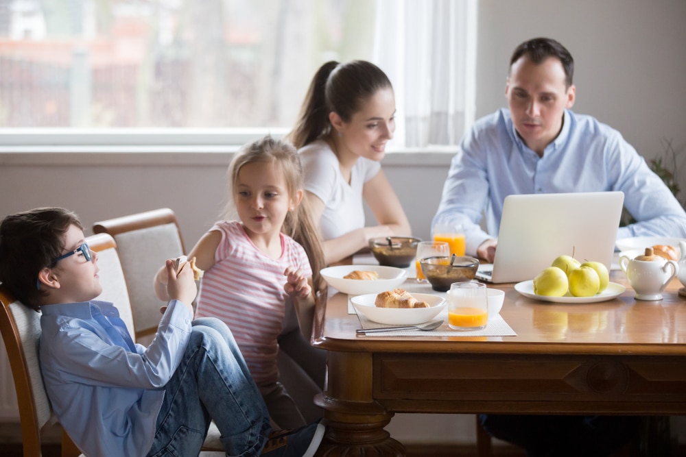 Happy family sitting around dining room table
