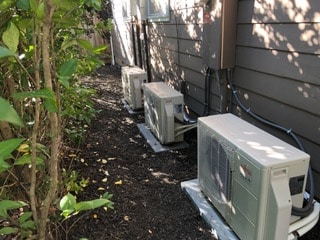 Heat pumps neatly installed outside home